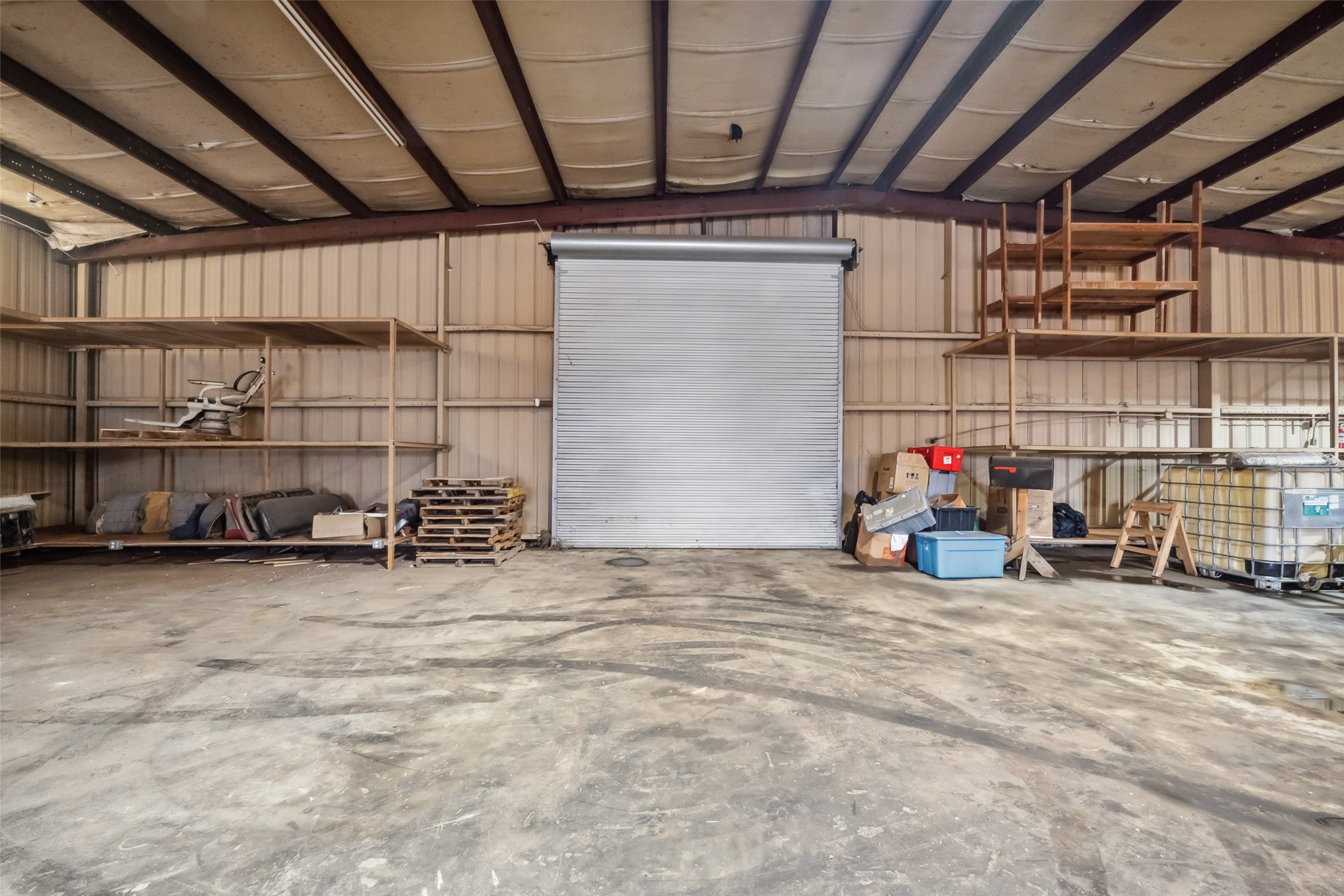 21405 Farm To Market 787 Cleveland, TX 77327 - Photo 3 of 24 The inside of the warehouse. Notice the ceiling is insulated. It includes shelving units offering ample storage and workspace potential.