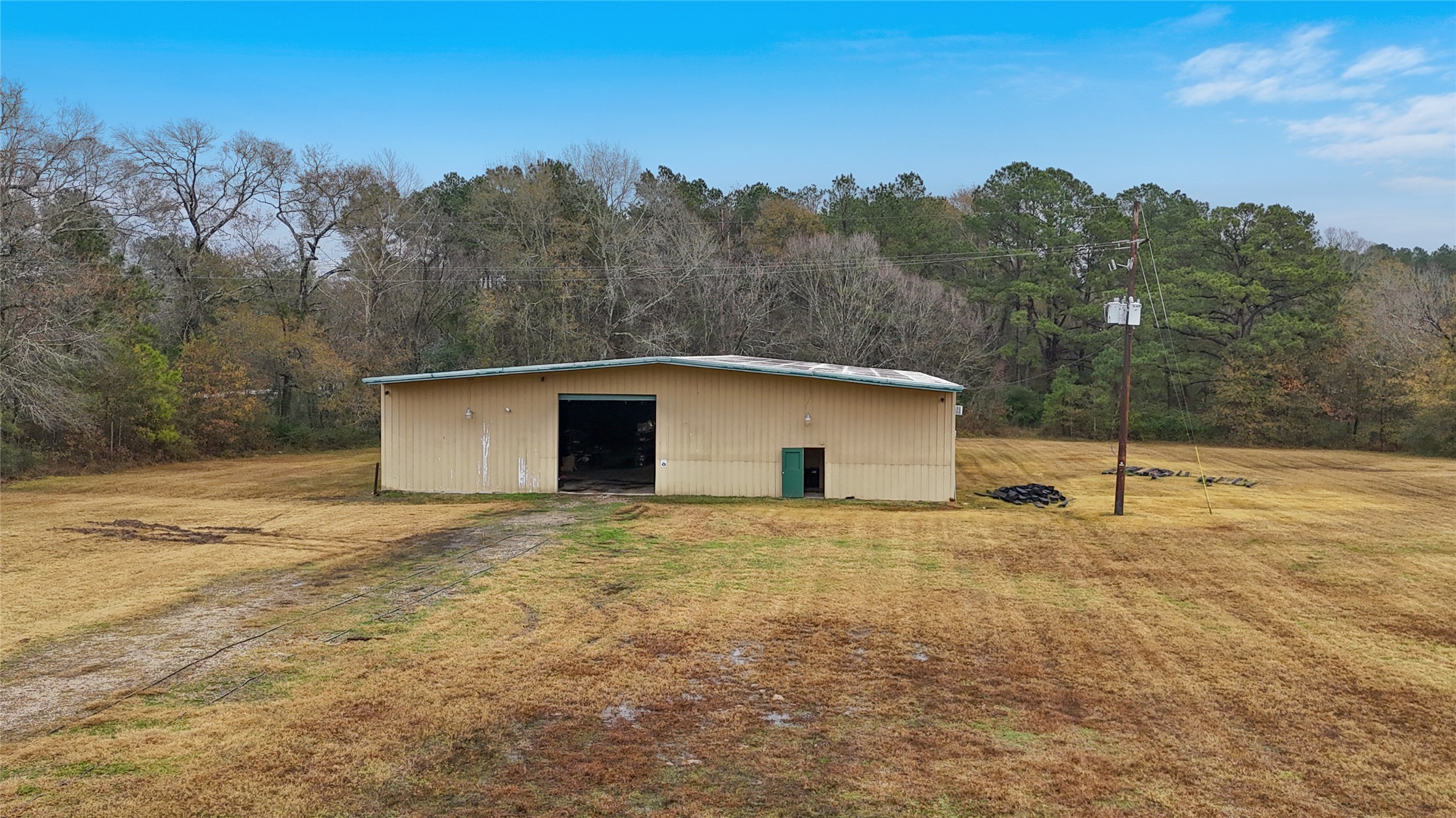 21405 Farm To Market 787 Cleveland, TX 77327 - Photo 10 of 24 The large, spacious metal building with 14 ft roll up doors on either side surrounded by lots of empty space is perfect for truck pull through for loading and storage