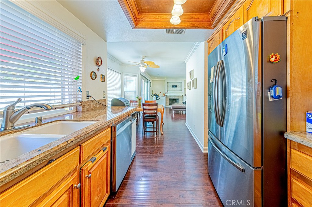 49 Stagecoach Drive Phillips Ranch, CA 91766 - Photo 11 of 39 a kitchen with stainless steel appliances granite countertop a refrigerator a stove and a sink