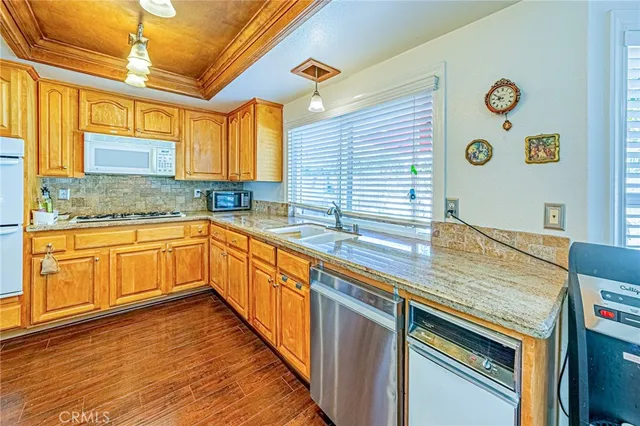 a kitchen with cabinets and wooden floor