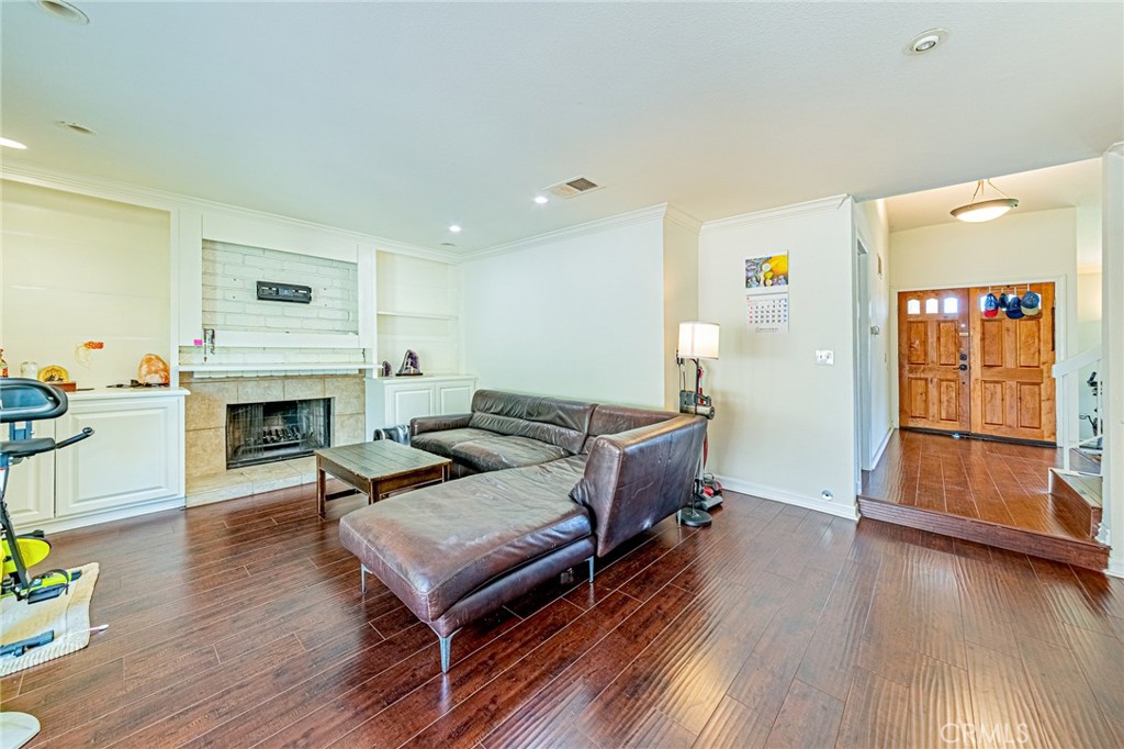 49 Stagecoach Drive Phillips Ranch, CA 91766 - Photo 13 of 39 a living room with furniture fireplace and wooden floor