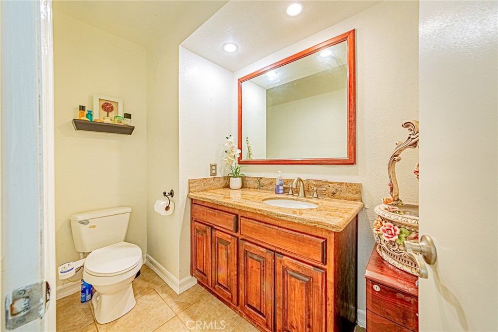 49 Stagecoach Drive Phillips Ranch, CA 91766 - Photo 16 of 39 a bathroom with a toilet sink and mirror