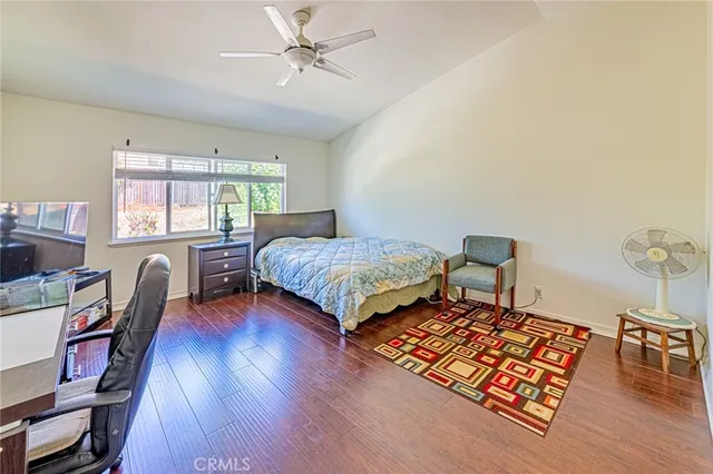 a bedroom with a bed window and a table