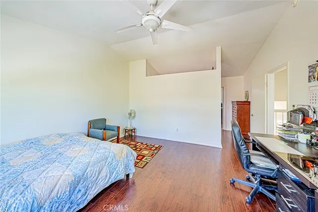a bedroom with a bed and a wooden floor