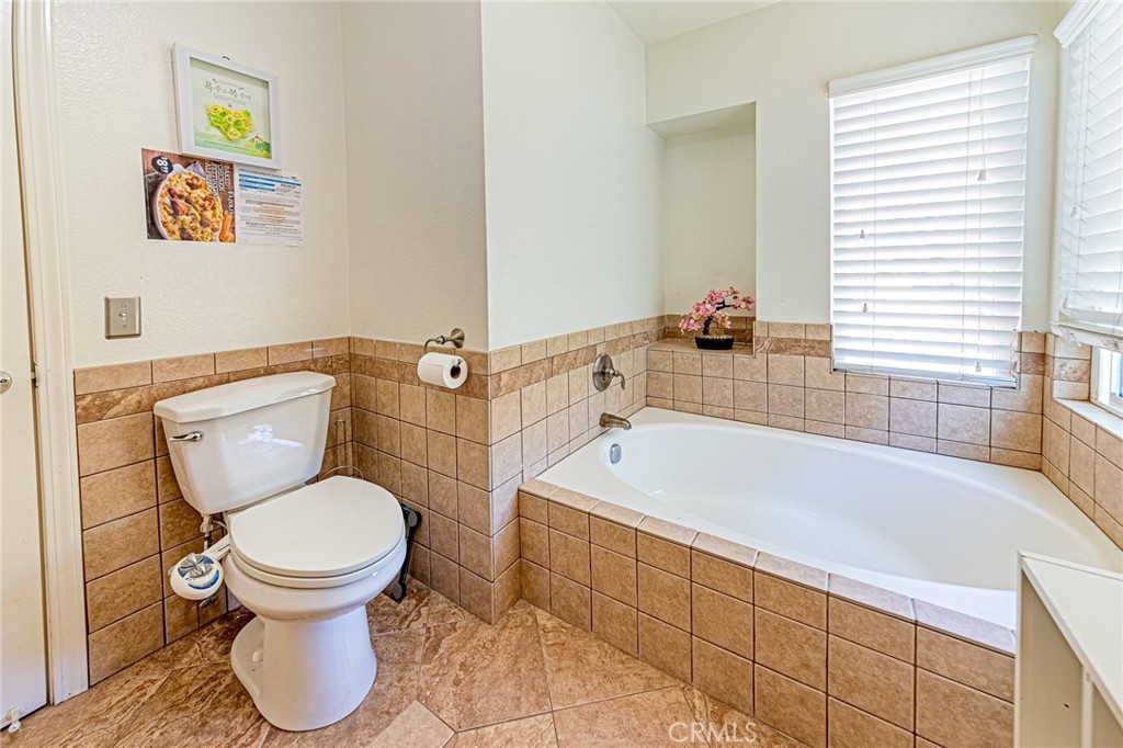 49 Stagecoach Drive Phillips Ranch, CA 91766 - Photo 24 of 39 a bathroom with a toilet and a bathtub