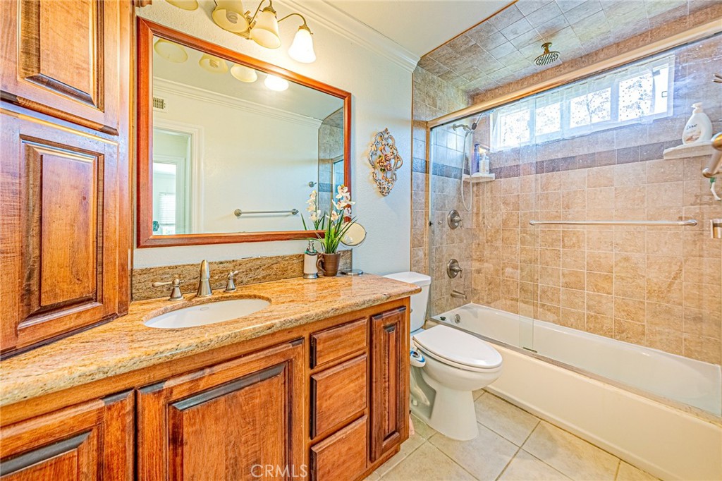 49 Stagecoach Drive Phillips Ranch, CA 91766 - Photo 27 of 39 a bathroom with a granite countertop sink toilet mirror and bathtub