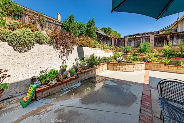 a view of a chairs and table in a backyard