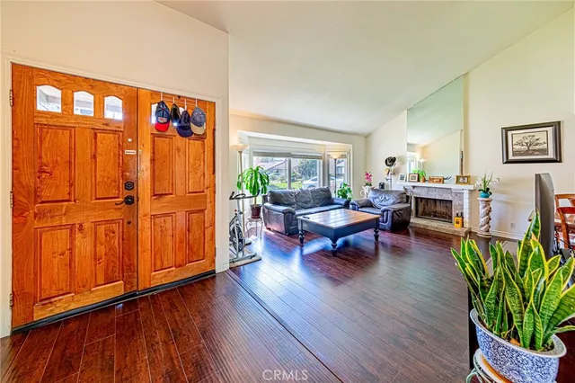 a living room with furniture a wooden floor and a window
