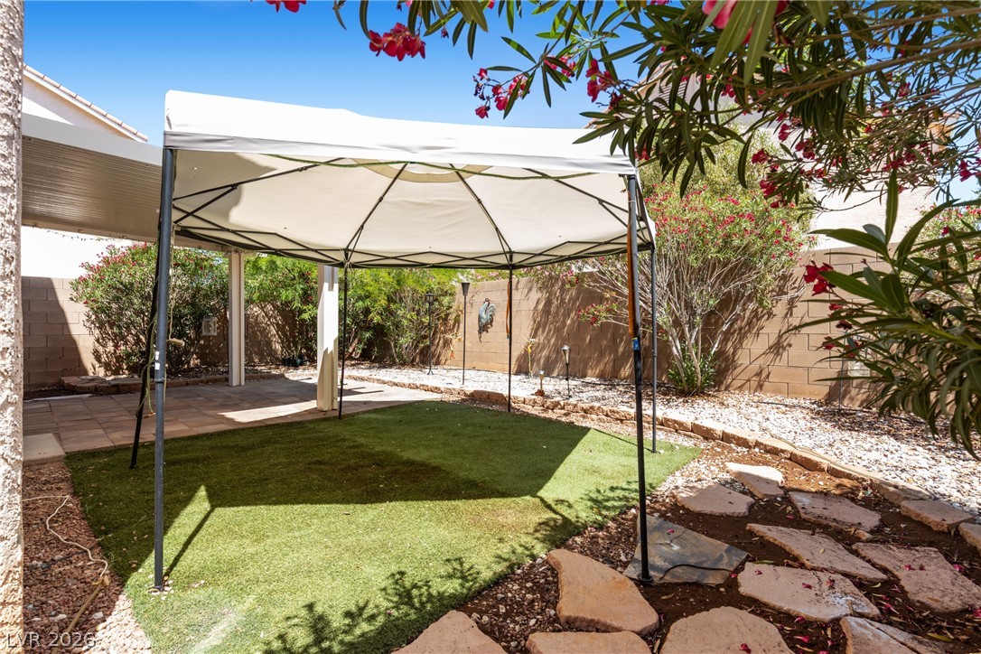 8934 Deep Ridge Court Las Vegas, NV 89178 - Photo 30 of 47 Enjoy outdoor living with a private yard featuring a covered patio area.