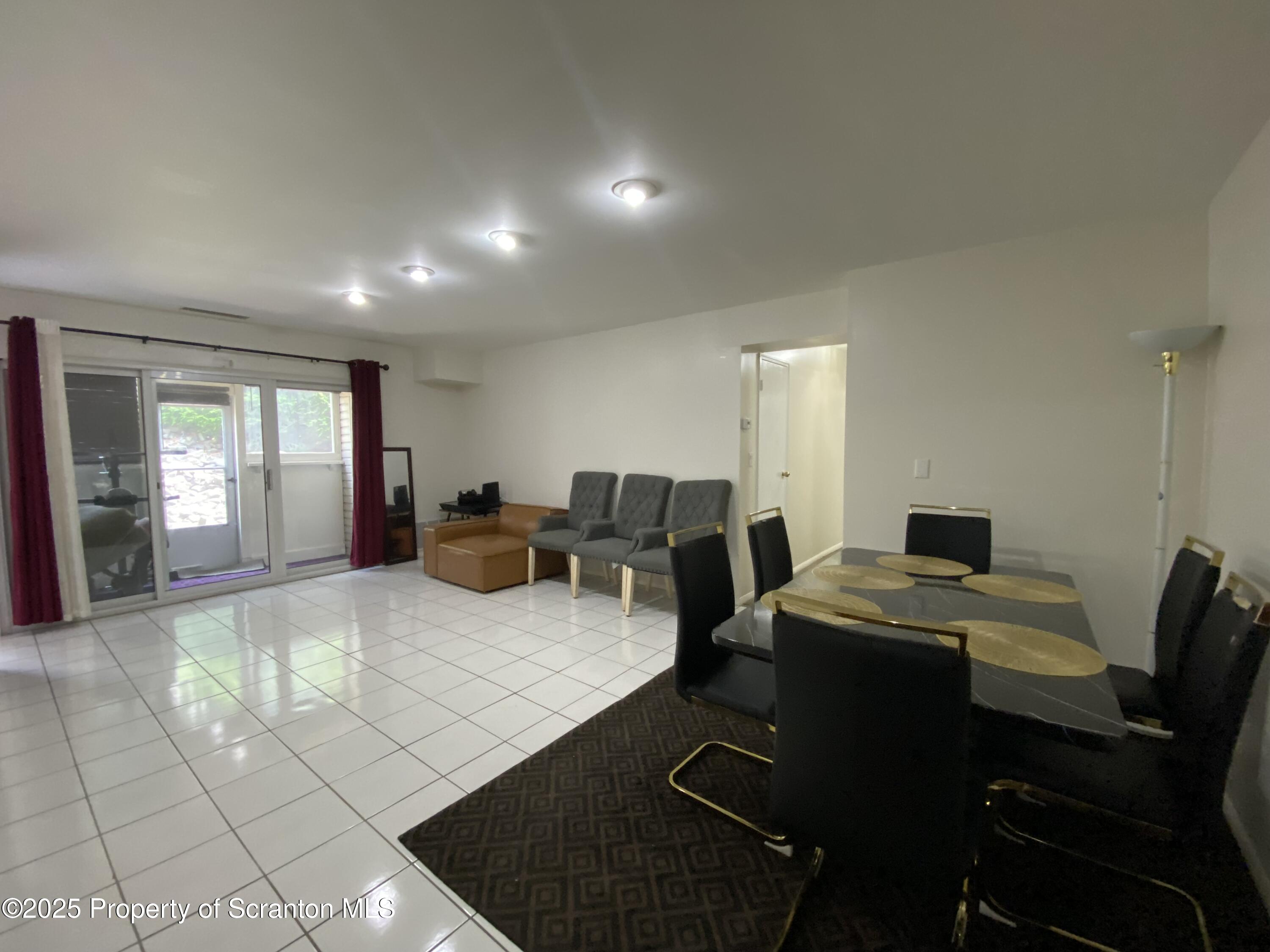 1501 Summit Pointe Scranton, PA 18508 - Photo 8 of 34 a living room with furniture a flat screen tv and next to a window