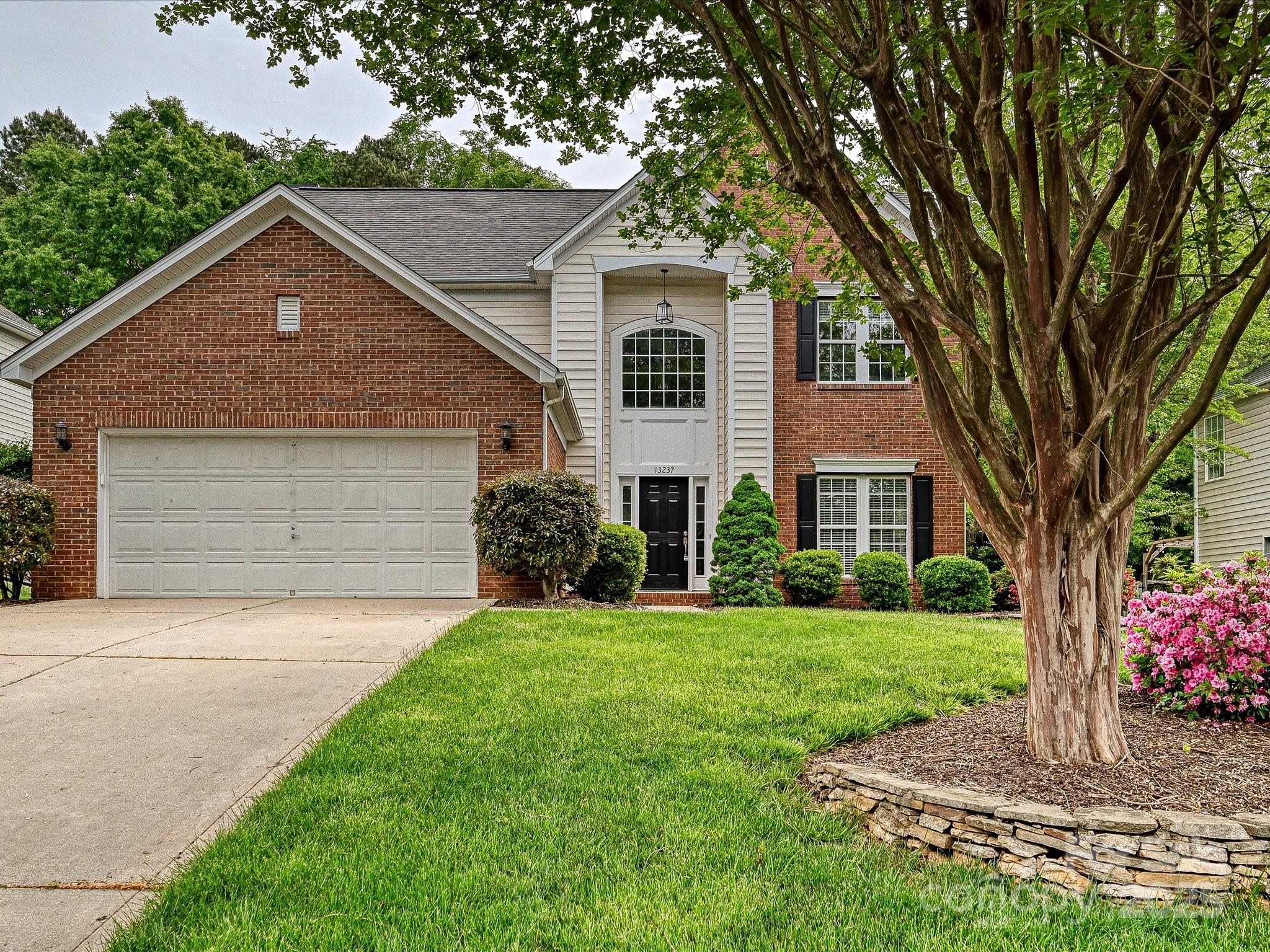 13237 Fremington Road Huntersville, NC 28078 - Photo 1 of 36 a front view of a house with a yard and garage