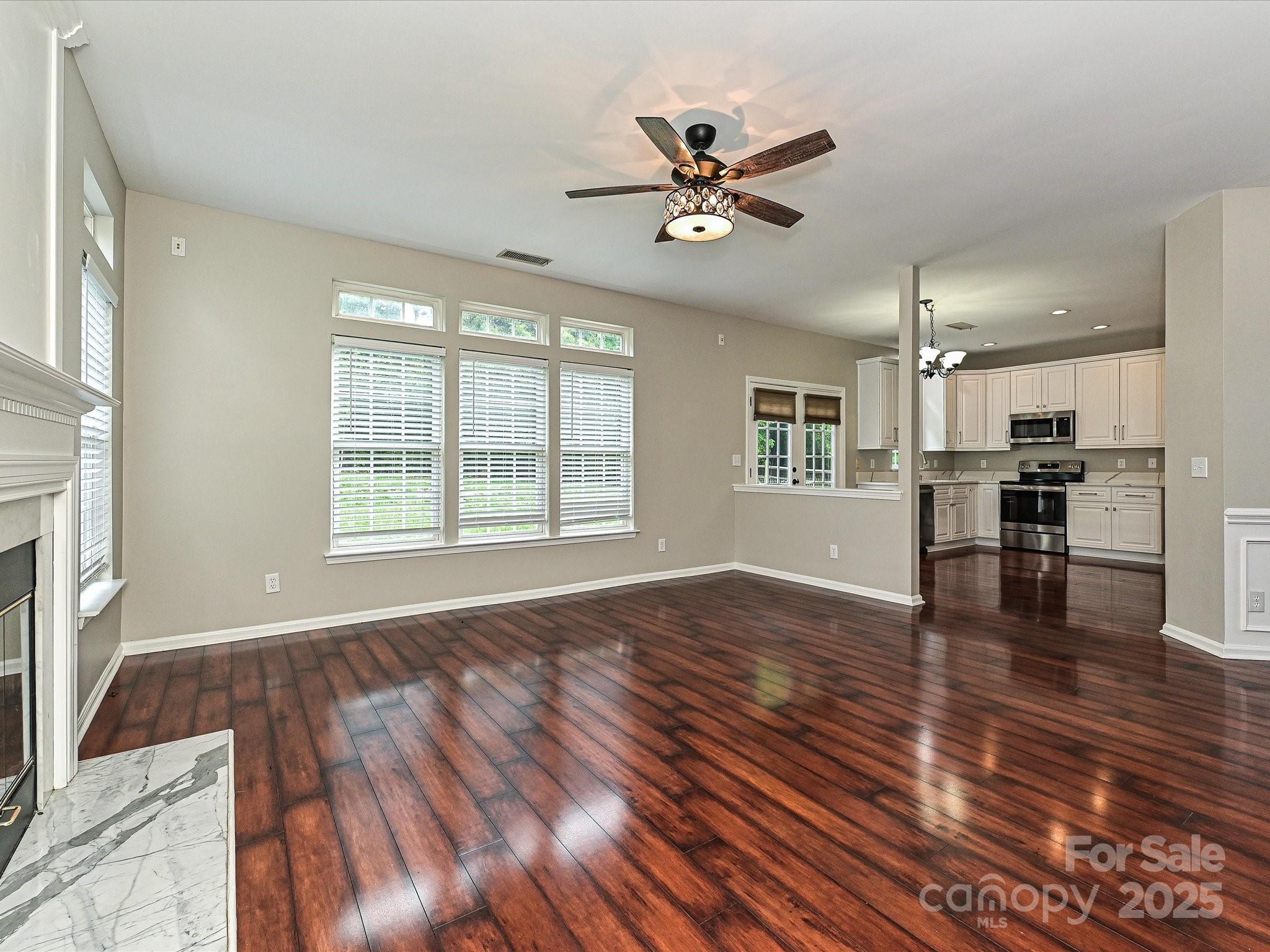 13237 Fremington Road Huntersville, NC 28078 - Photo 11 of 36 a view of an empty room with wooden floor and a window