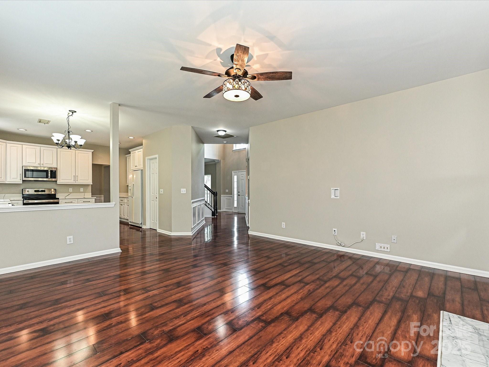 13237 Fremington Road Huntersville, NC 28078 - Photo 13 of 36 a view of a room with wooden floor and a ceiling fan