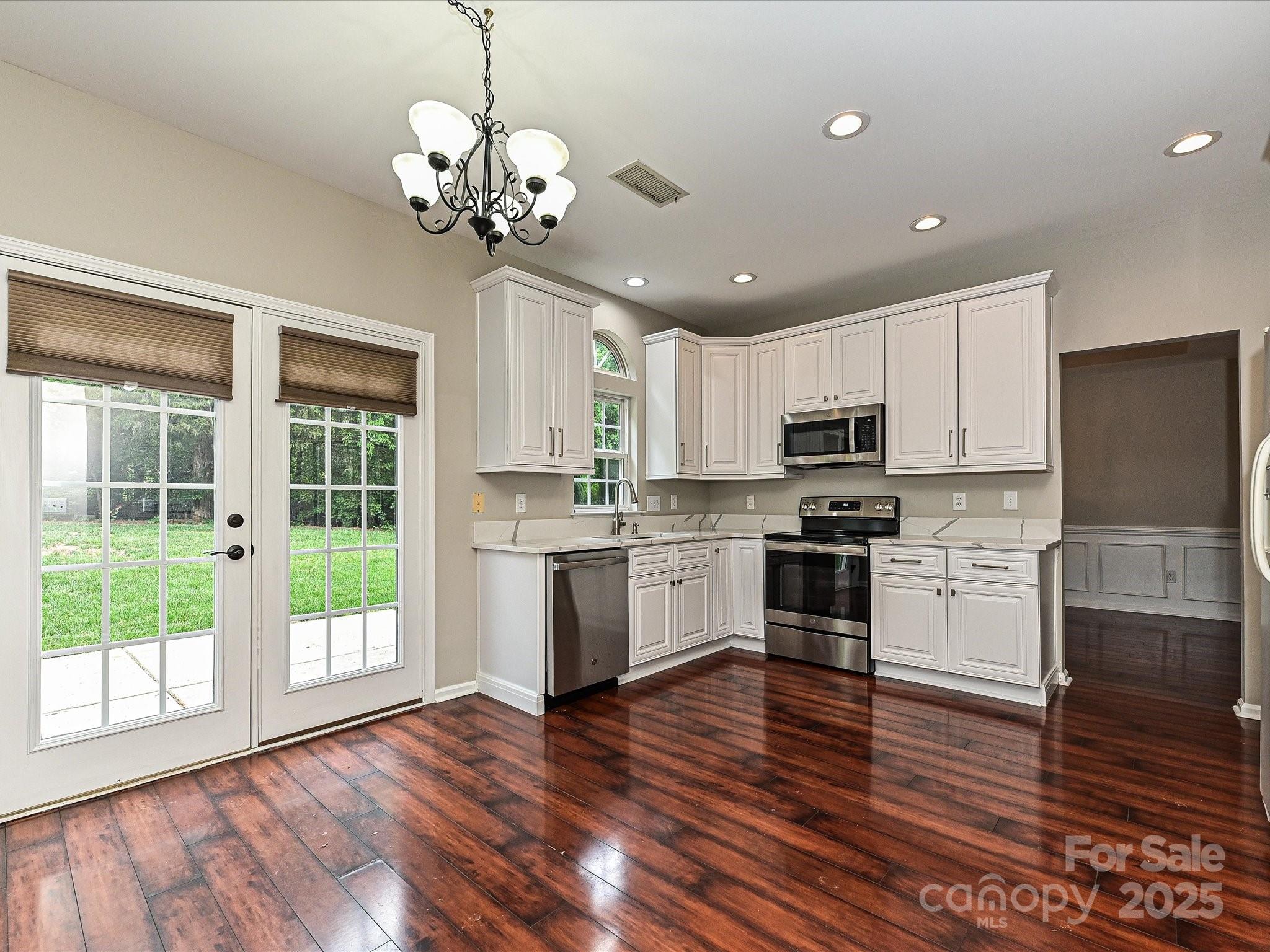 13237 Fremington Road Huntersville, NC 28078 - Photo 14 of 36 a kitchen with kitchen island granite countertop stainless steel appliances a stove and a window