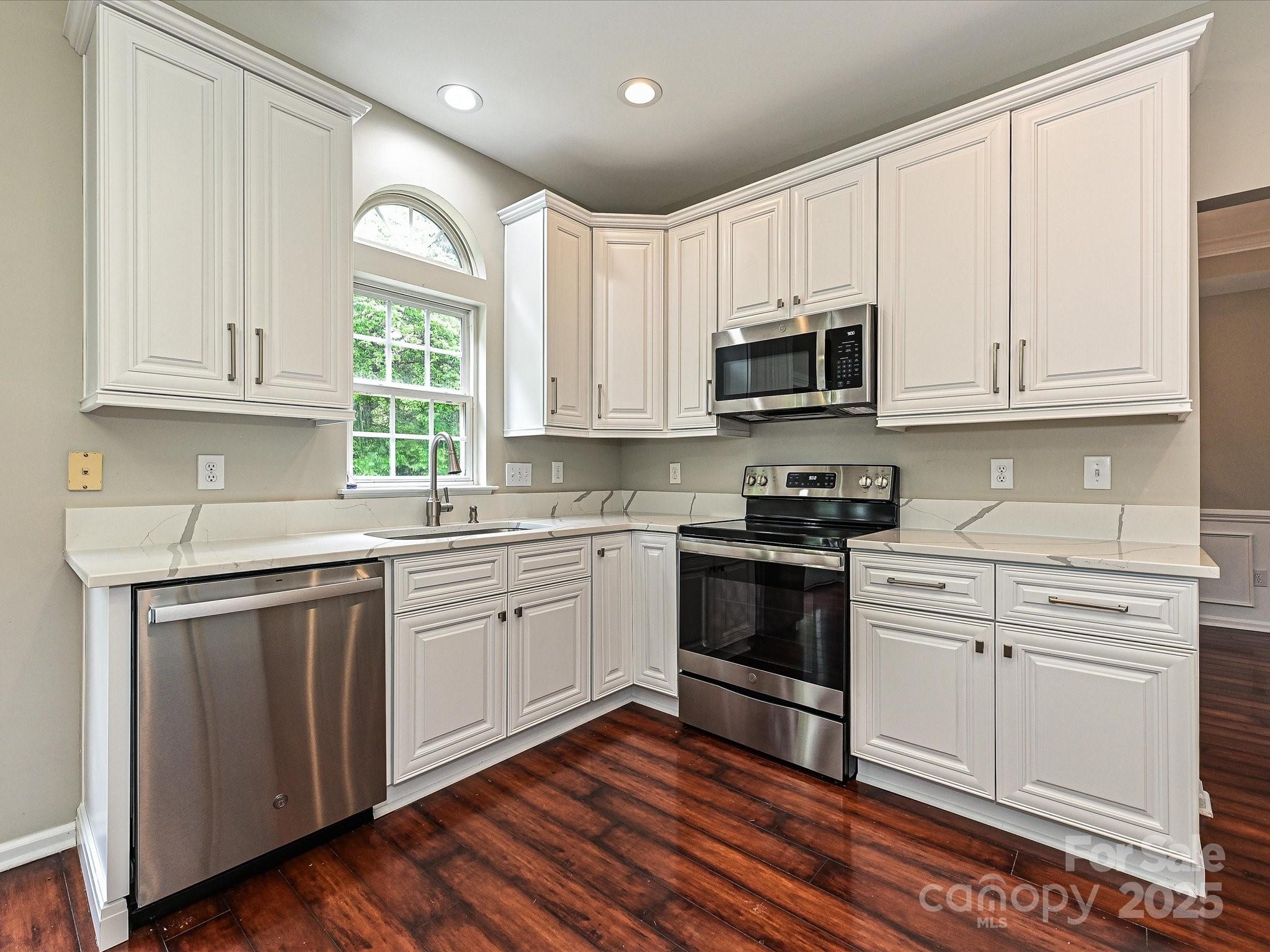 13237 Fremington Road Huntersville, NC 28078 - Photo 15 of 36 a kitchen with granite countertop cabinets stainless steel appliances and window