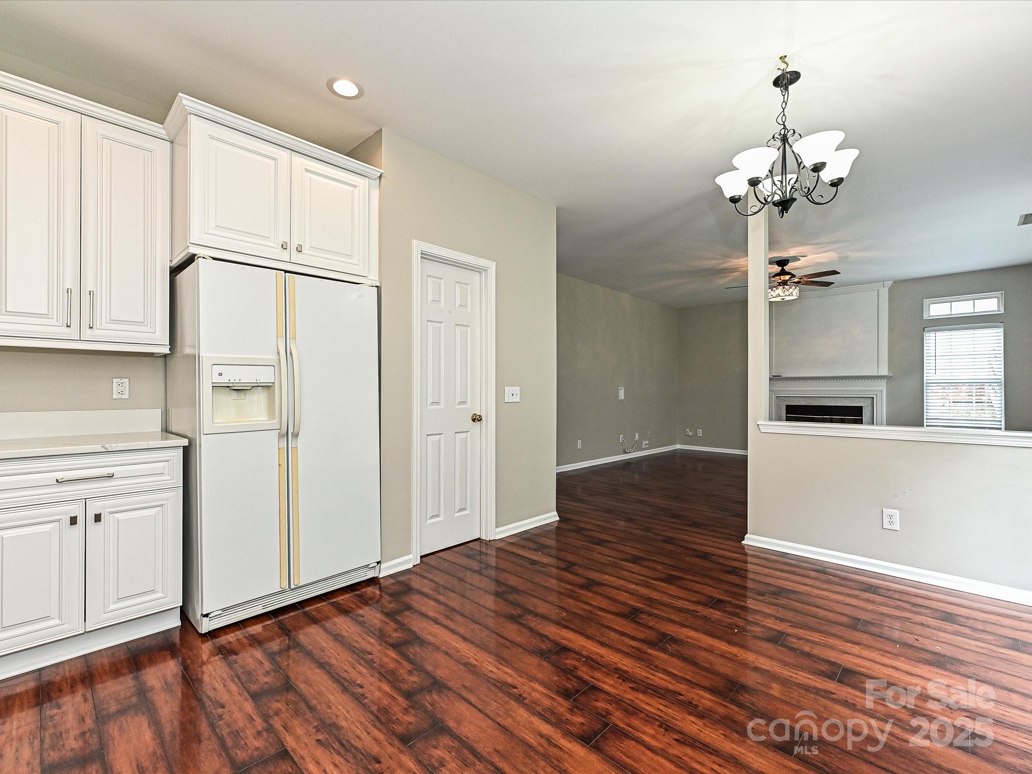 13237 Fremington Road Huntersville, NC 28078 - Photo 17 of 36 a view of a kitchen with wooden floor and a refrigerator