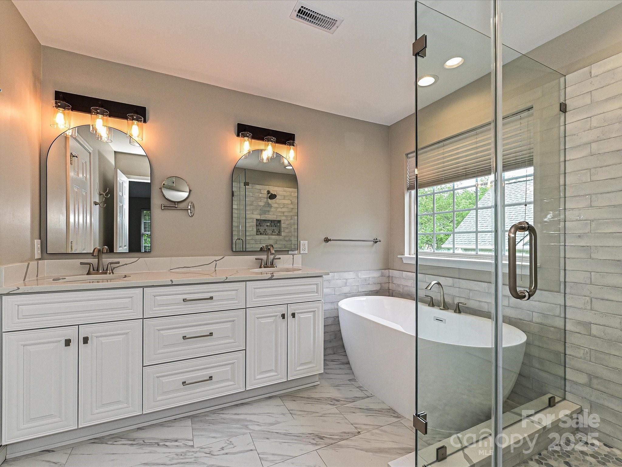 13237 Fremington Road Huntersville, NC 28078 - Photo 23 of 36 a bathroom with a granite countertop sink mirror and bathtub