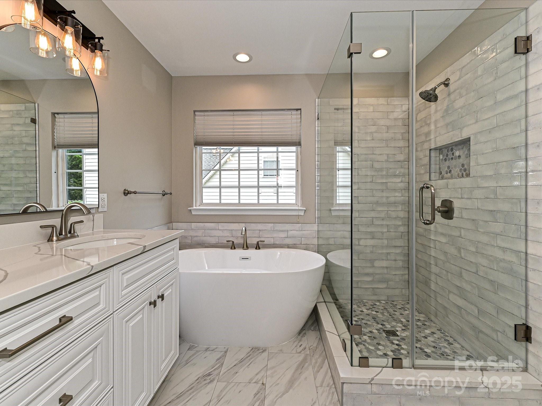 13237 Fremington Road Huntersville, NC 28078 - Photo 24 of 36 a spacious bathroom with a double vanity sink mirror and bathtub