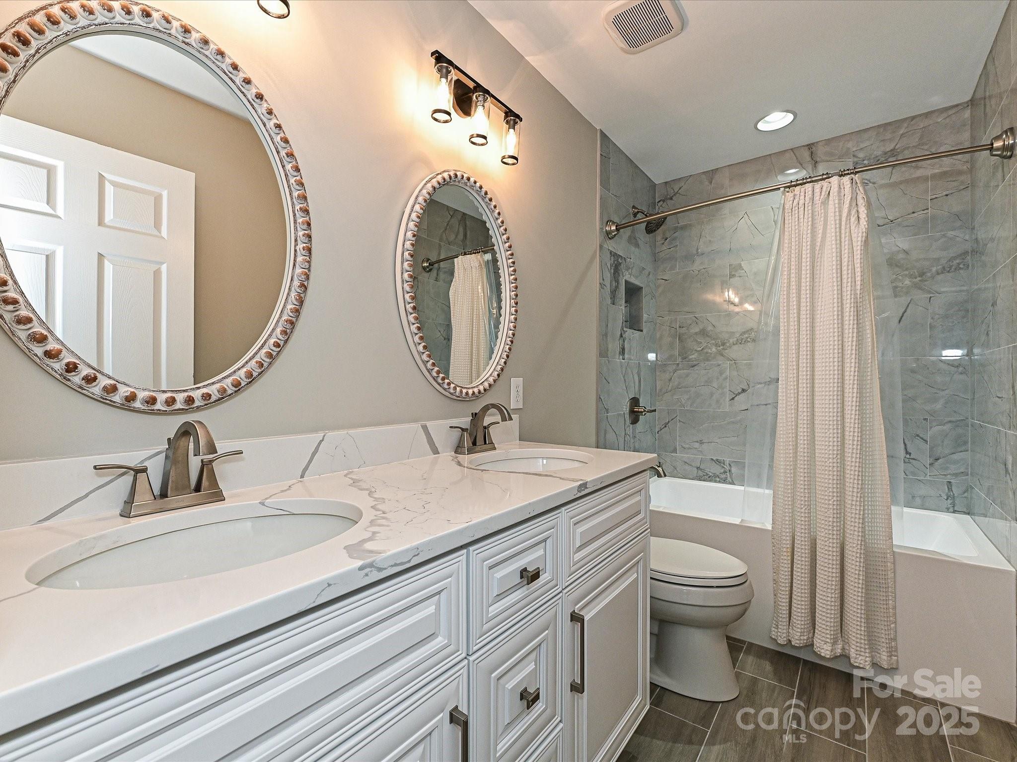 13237 Fremington Road Huntersville, NC 28078 - Photo 27 of 36 a bathroom with a granite countertop sink mirror vanity and toilet