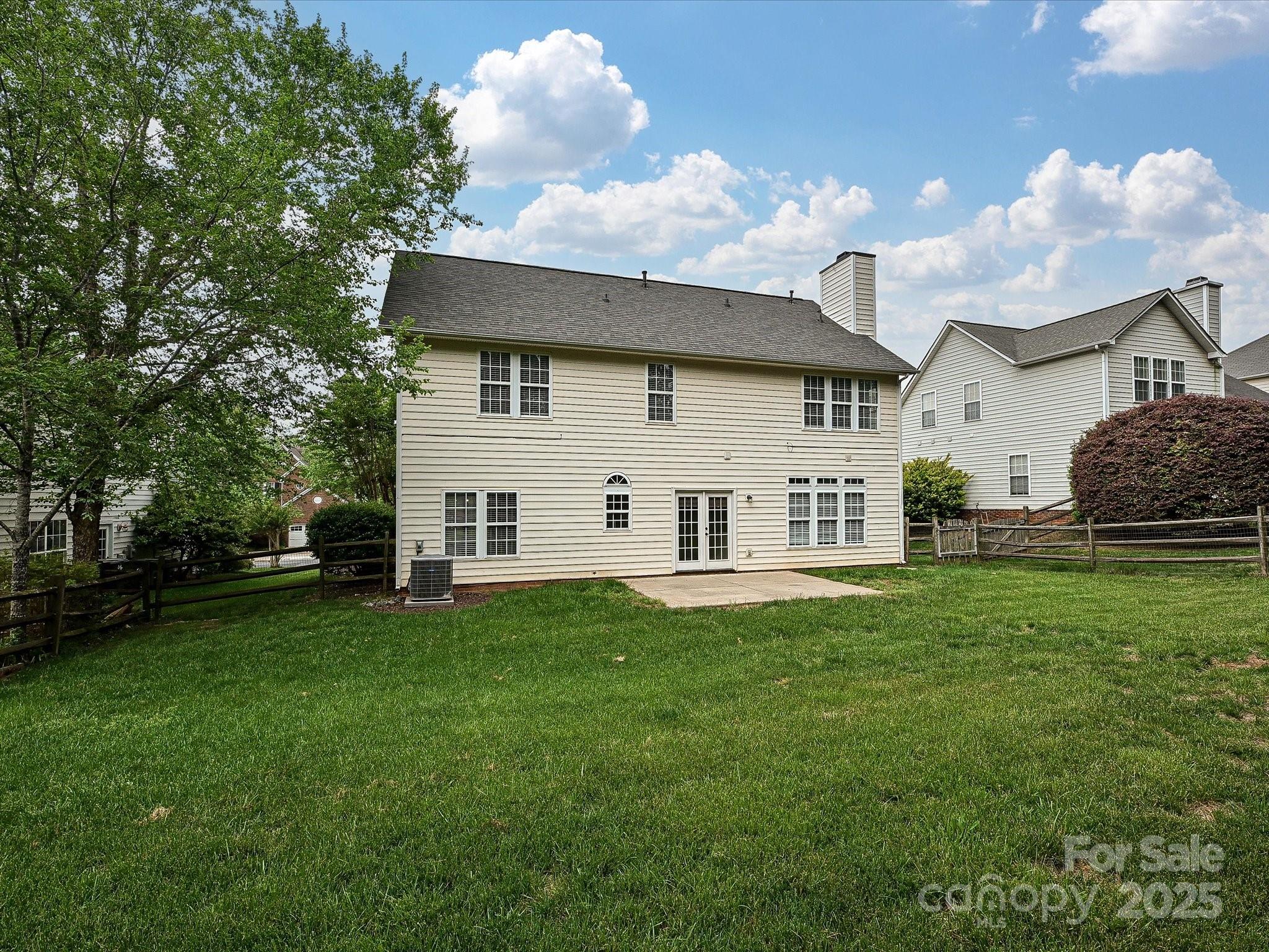 13237 Fremington Road Huntersville, NC 28078 - Photo 31 of 36 a white house that has a big yard with wooden fence