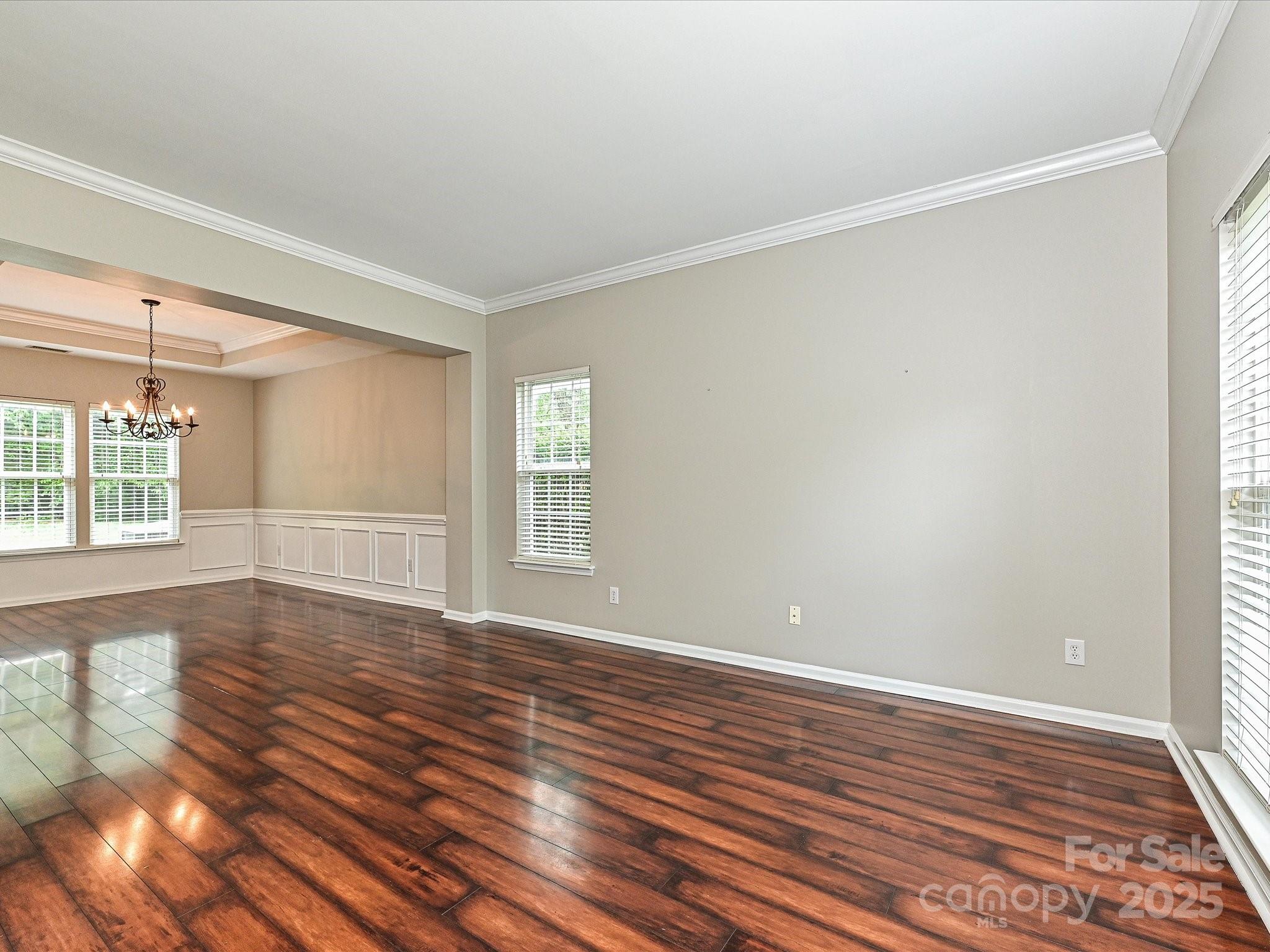 13237 Fremington Road Huntersville, NC 28078 - Photo 5 of 36 a view of an empty room with wooden floor and a window