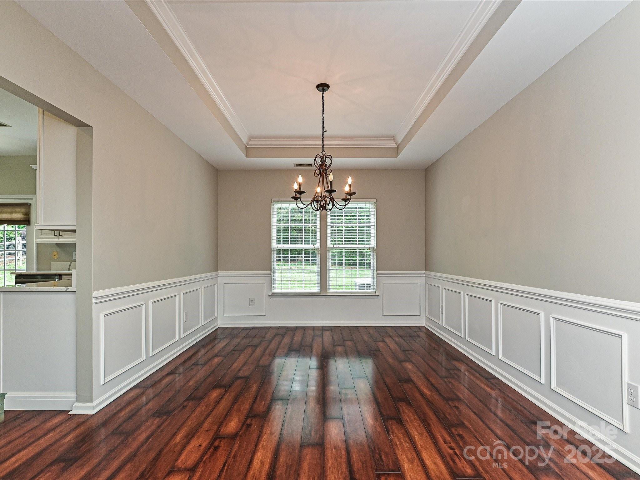 13237 Fremington Road Huntersville, NC 28078 - Photo 7 of 36 a view of an empty room with wooden floor and a window