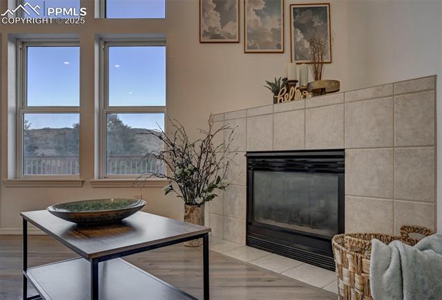 7790 Julynn Road Colorado Springs, CO 80919 - Photo 10 of 50 Cozy up to the gas fireplace with tile surround on chilly Colorado nights.