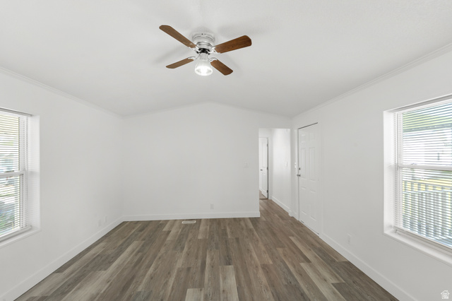 2600 North Hill Field Road, Unit 103A Layton, UT 84041 - Photo 11 of 31 Spacious room featuring wood-finish flooring, bright white walls, and a vaulted ceiling with a ceiling fan