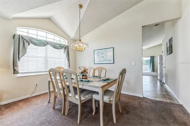 a dining room with furniture and window