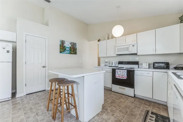 a kitchen with a stove cabinets and a refrigerator