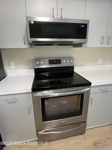 a stove top oven sitting inside of a kitchen