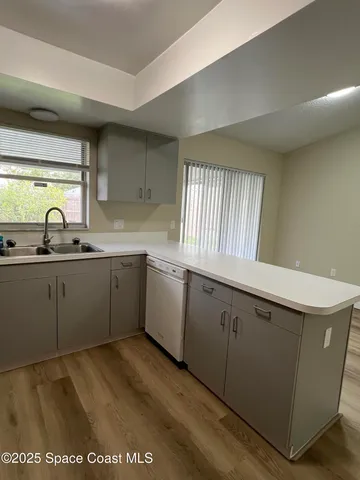 a kitchen with a sink cabinets and window