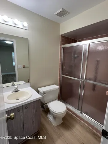 a white toilet sitting next to a bathroom sink