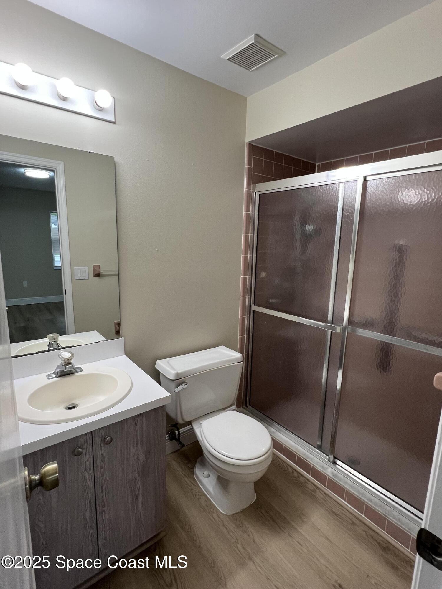 3154 Dunhill Drive Cocoa, FL 32926 - Photo 18 of 19 a white toilet sitting next to a bathroom sink