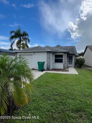 a view of a house with a backyard and porch
