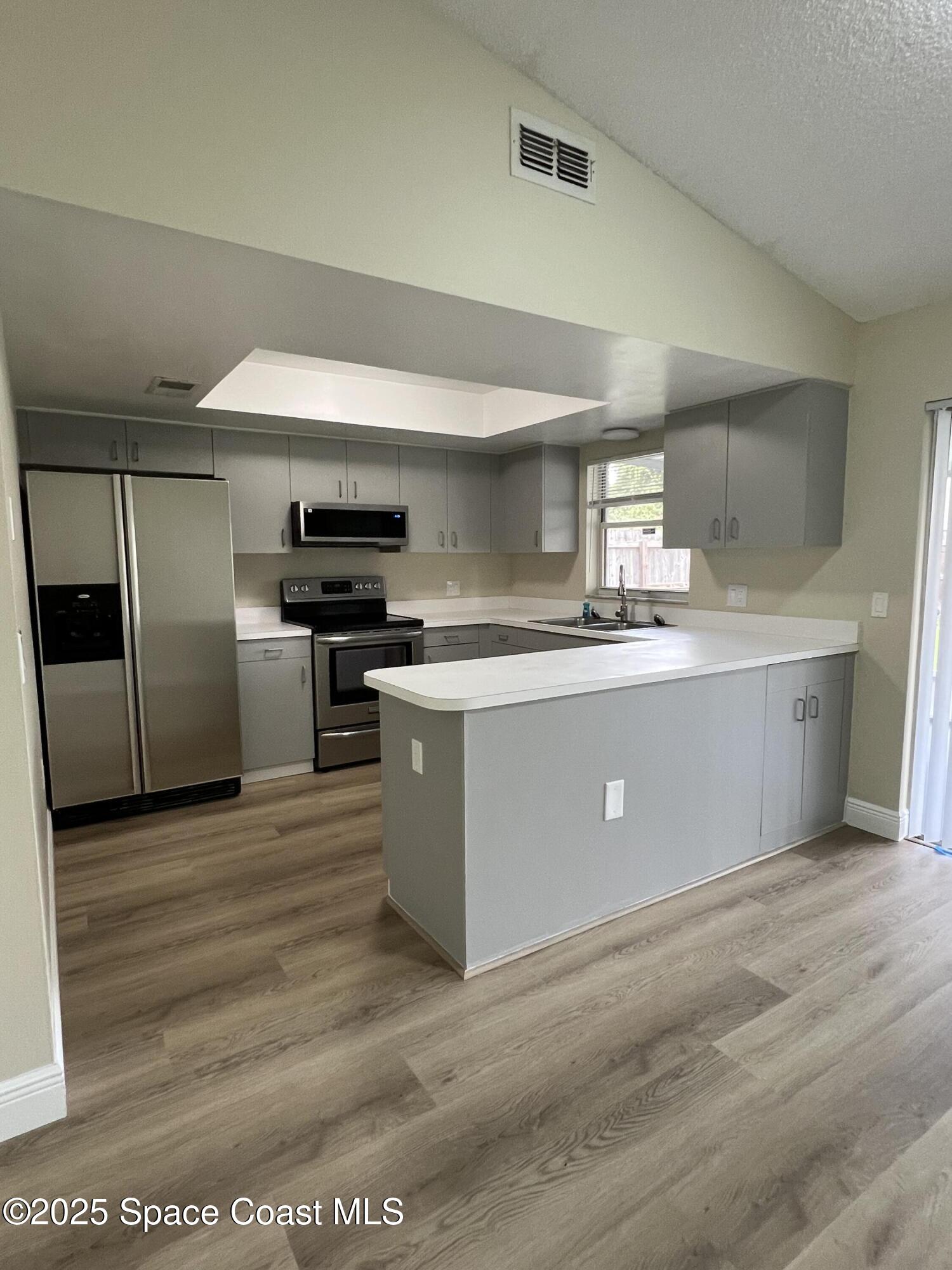 3154 Dunhill Drive Cocoa, FL 32926 - Photo 9 of 19 a kitchen with stainless steel appliances granite countertop a stove a sink and a refrigerator