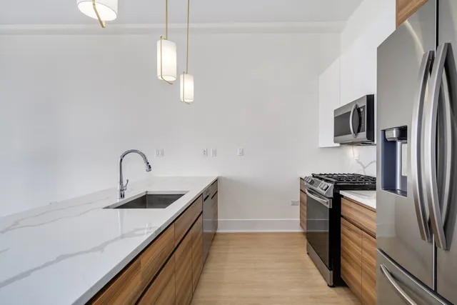 a kitchen with kitchen island a sink and wooden floor