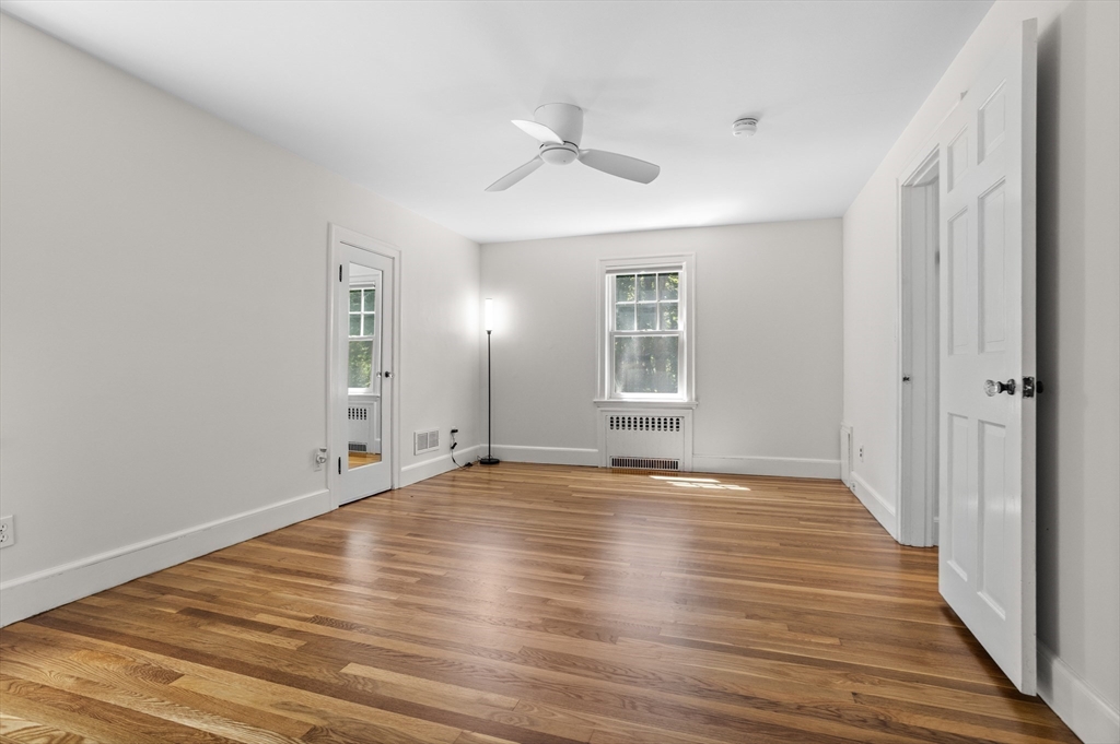 38 Wachusett Drive Lexington, MA 02421 - Photo 17 of 30 wooden floor in an empty room with a window