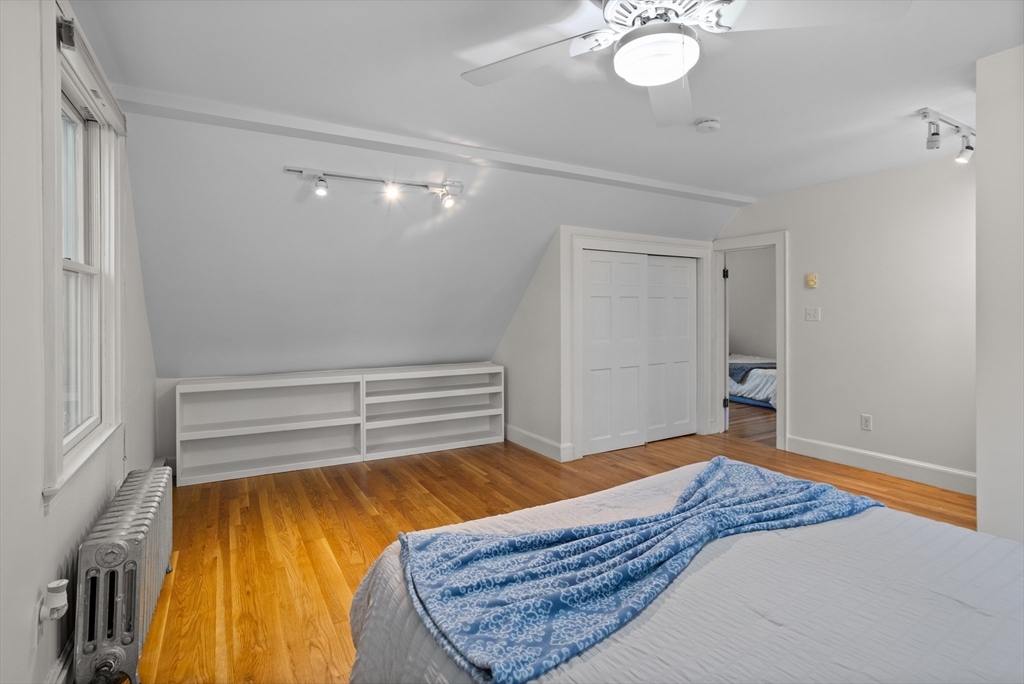 38 Wachusett Drive Lexington, MA 02421 - Photo 23 of 30 a bedroom with a bed and a chandelier