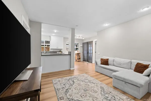 a living room with furniture and kitchen view