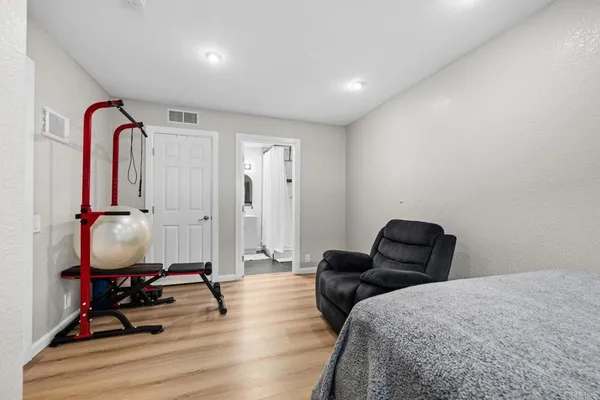 a bedroom with furniture and a closet