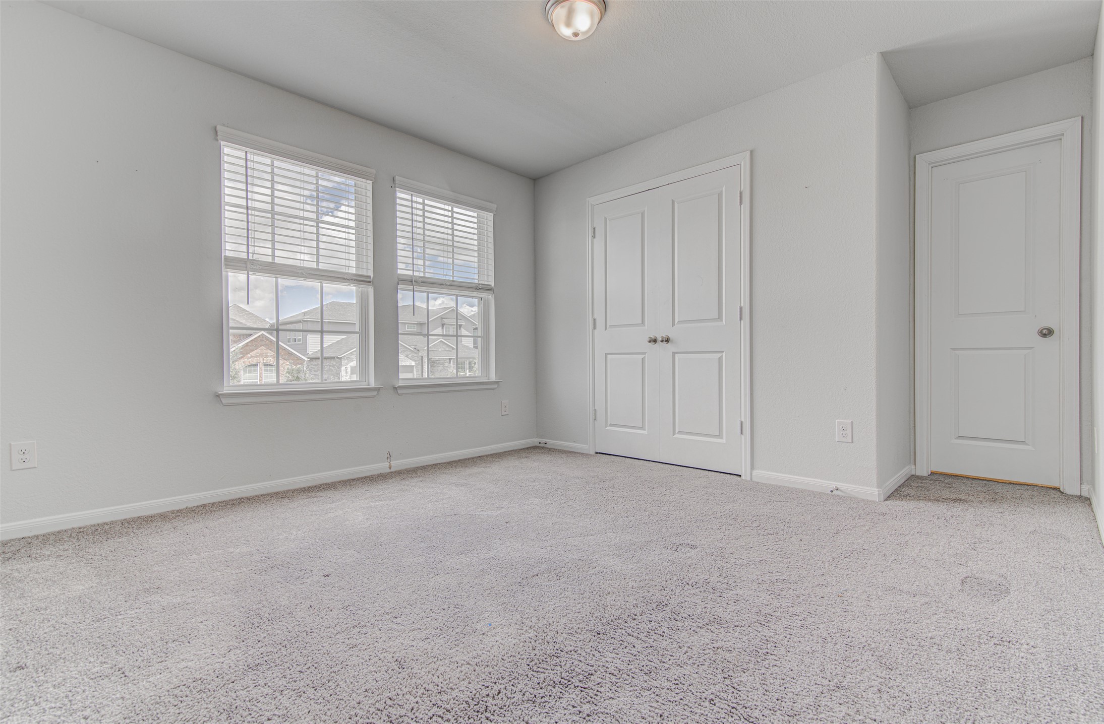 774 Cherrystone Loop Buda, TX 78610 - Photo 23 of 38 Bright windows and soft carpeting define this inviting, cozy bedroom space.