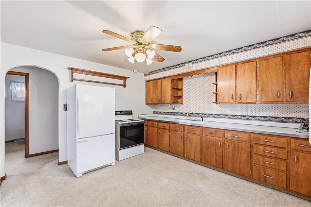 3489 Sample Road Hermitage, PA 16148 - Photo 13 of 33 a kitchen with stainless steel appliances granite countertop a refrigerator a sink dishwasher a stove with white cabinets and wooden floor