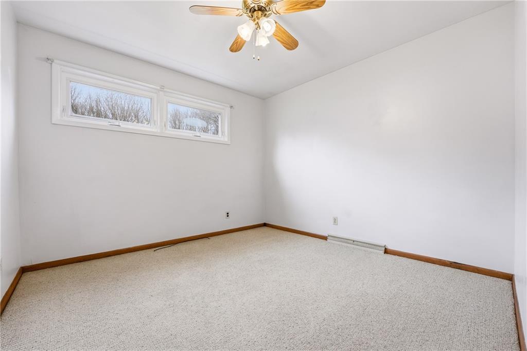 3489 Sample Road Hermitage, PA 16148 - Photo 21 of 33 an empty room with a chandelier fan and windows