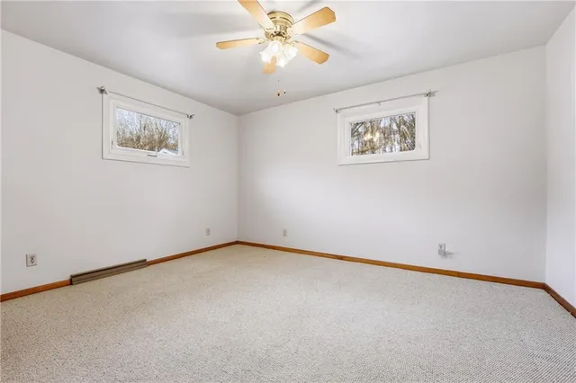 an empty room with a painting on the wall