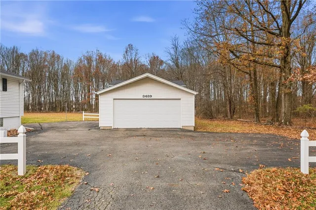 a view of a house with a yard and tree s