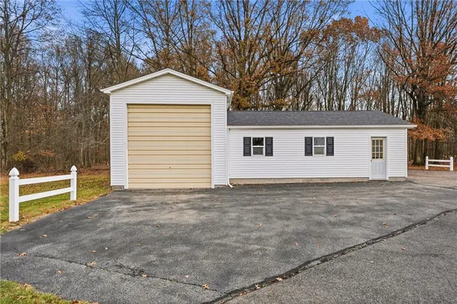 a view of a house with a yard and garage