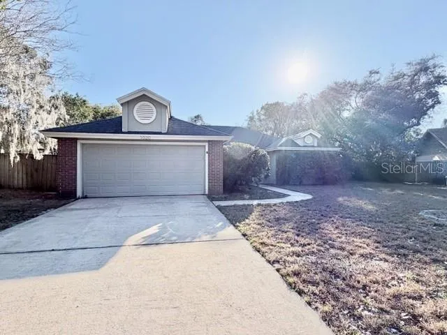 a view of a house with a yard and a garage