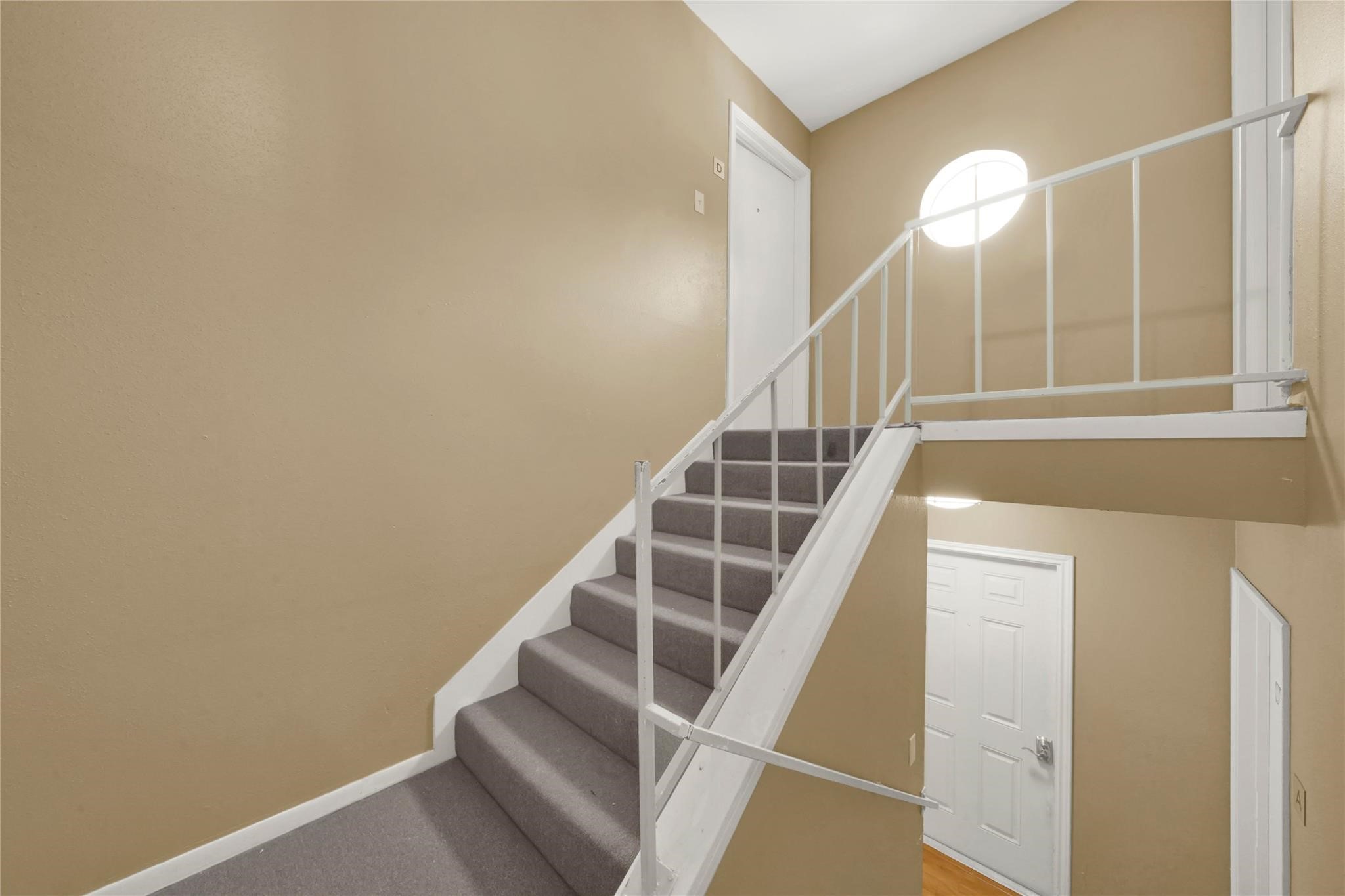 1815 Commonwealth Street, Unit D Houston, TX 77006 - Photo 19 of 23 a view of staircase with wooden floor and white walls