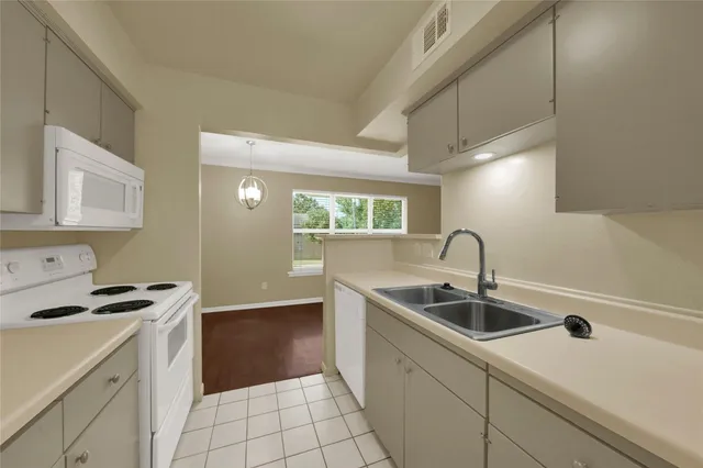 a kitchen with a sink cabinets and appliances